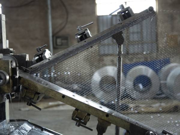 Stretch and form the expanded metal lath